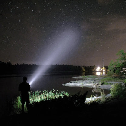 Cree Lighting X30 long-range flashlight beam reaching across a dark lake toward distant shoreline lights