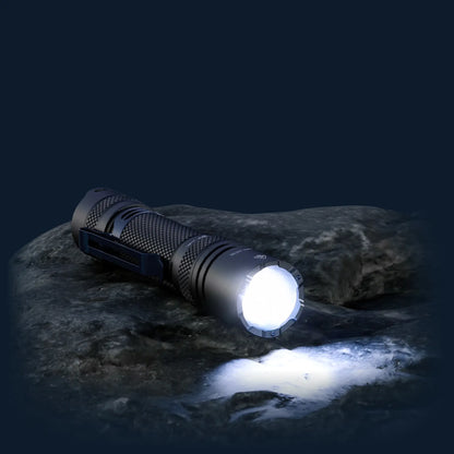 Cree Lighting X30 long-range flashlight illuminated on wet rock at night with beam on